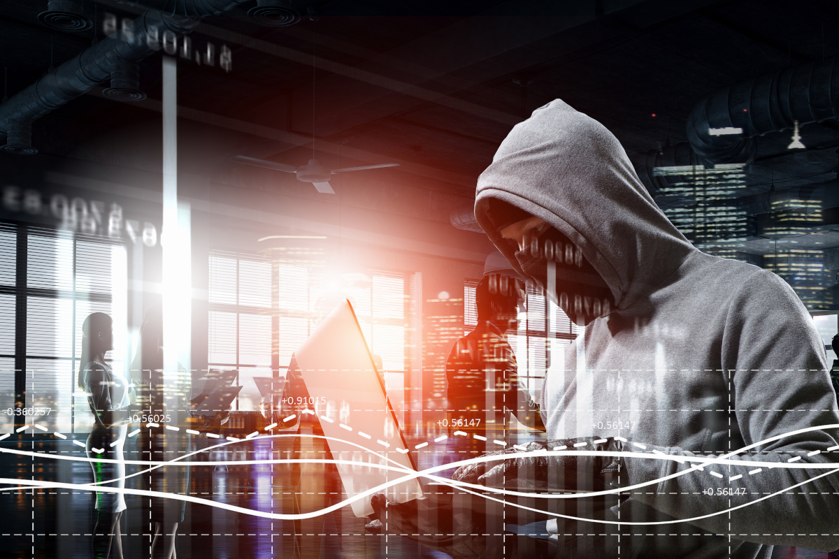 Hacker working in shadows