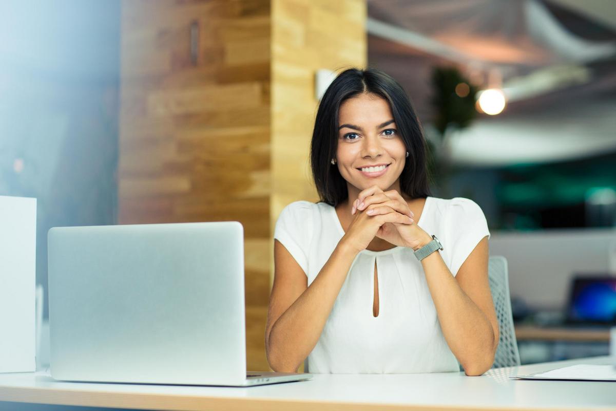 Woman sitting at office desk and smiling