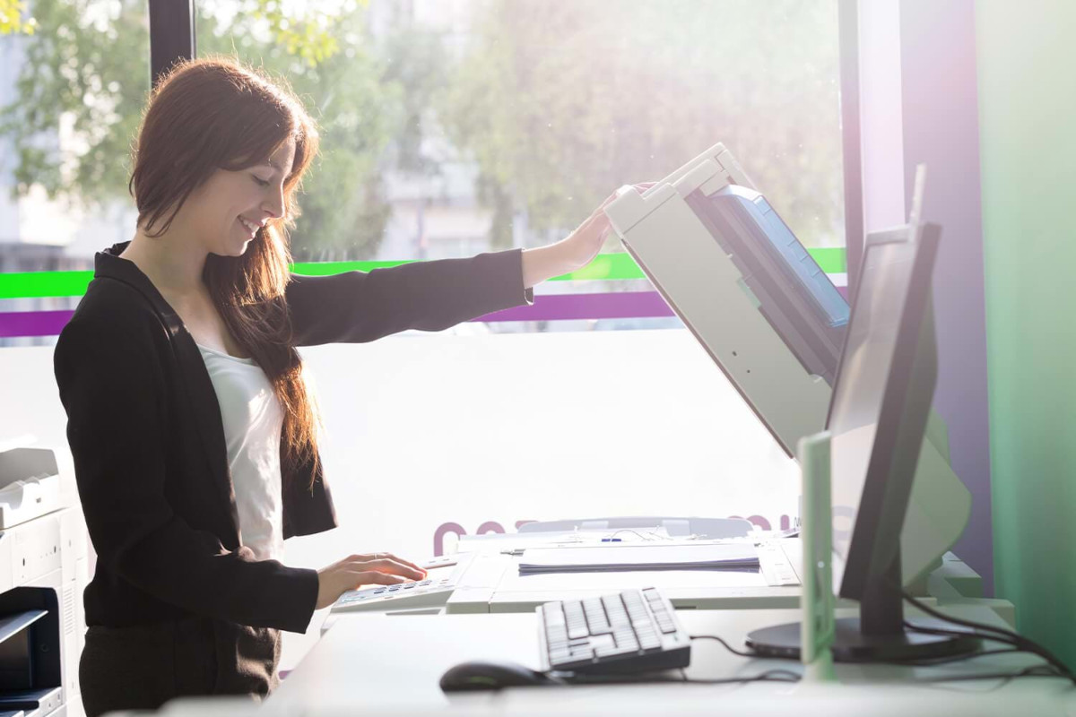 Woman Using Printer in an Office