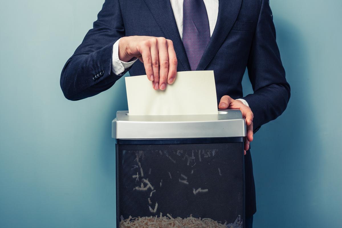 Businessman shreding paper