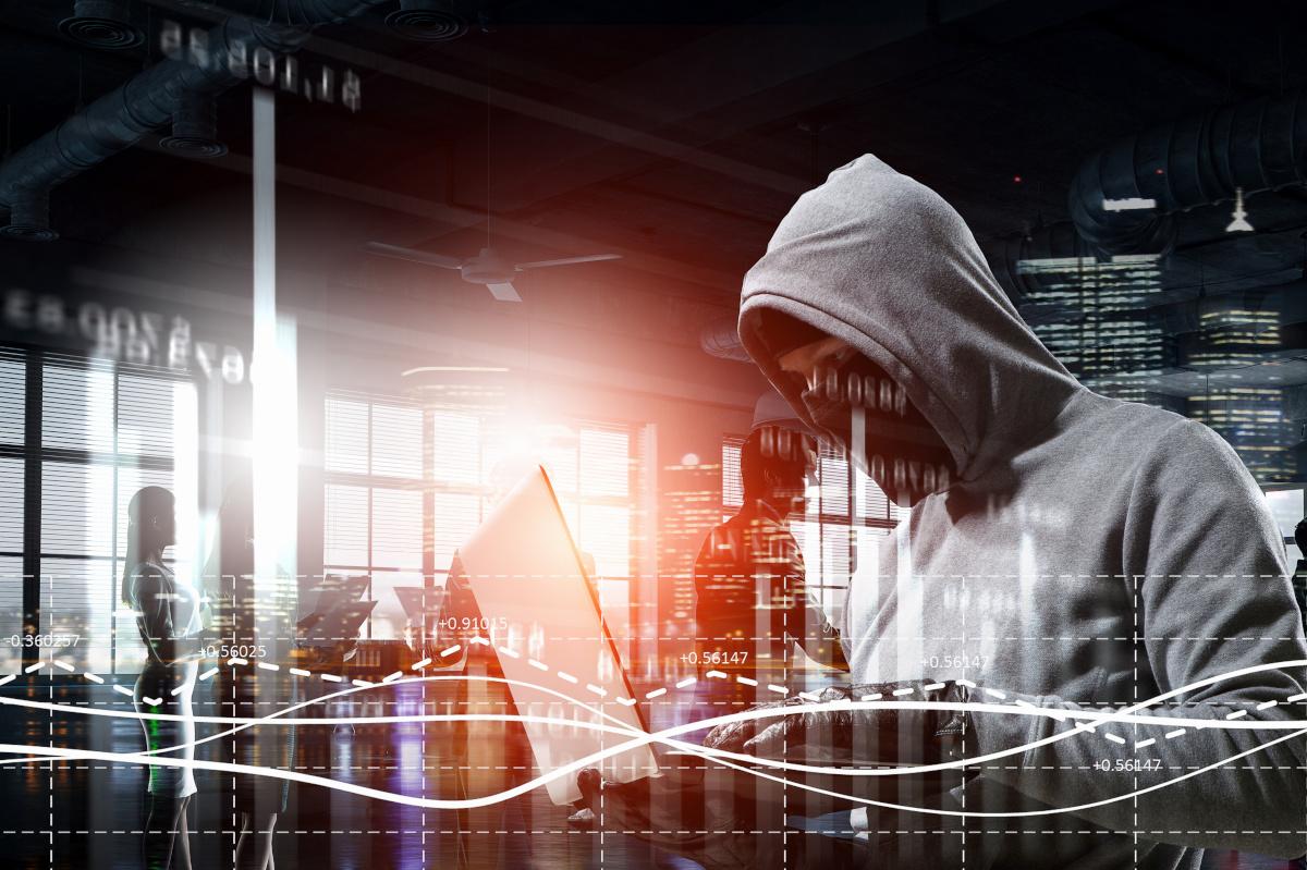 Hacker working in shadows