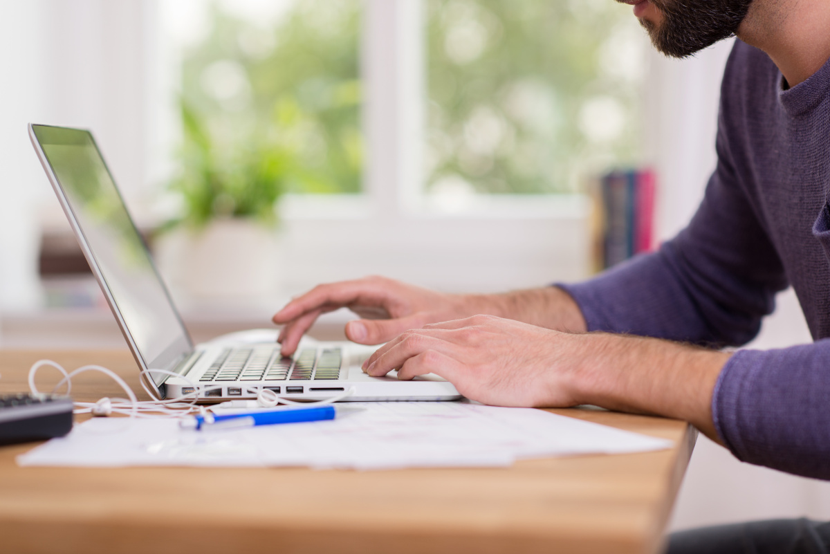 A person working remotely using their laptop