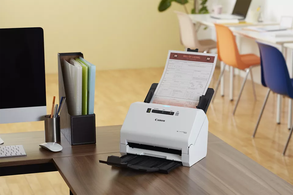 Woman placing a document in a scanner