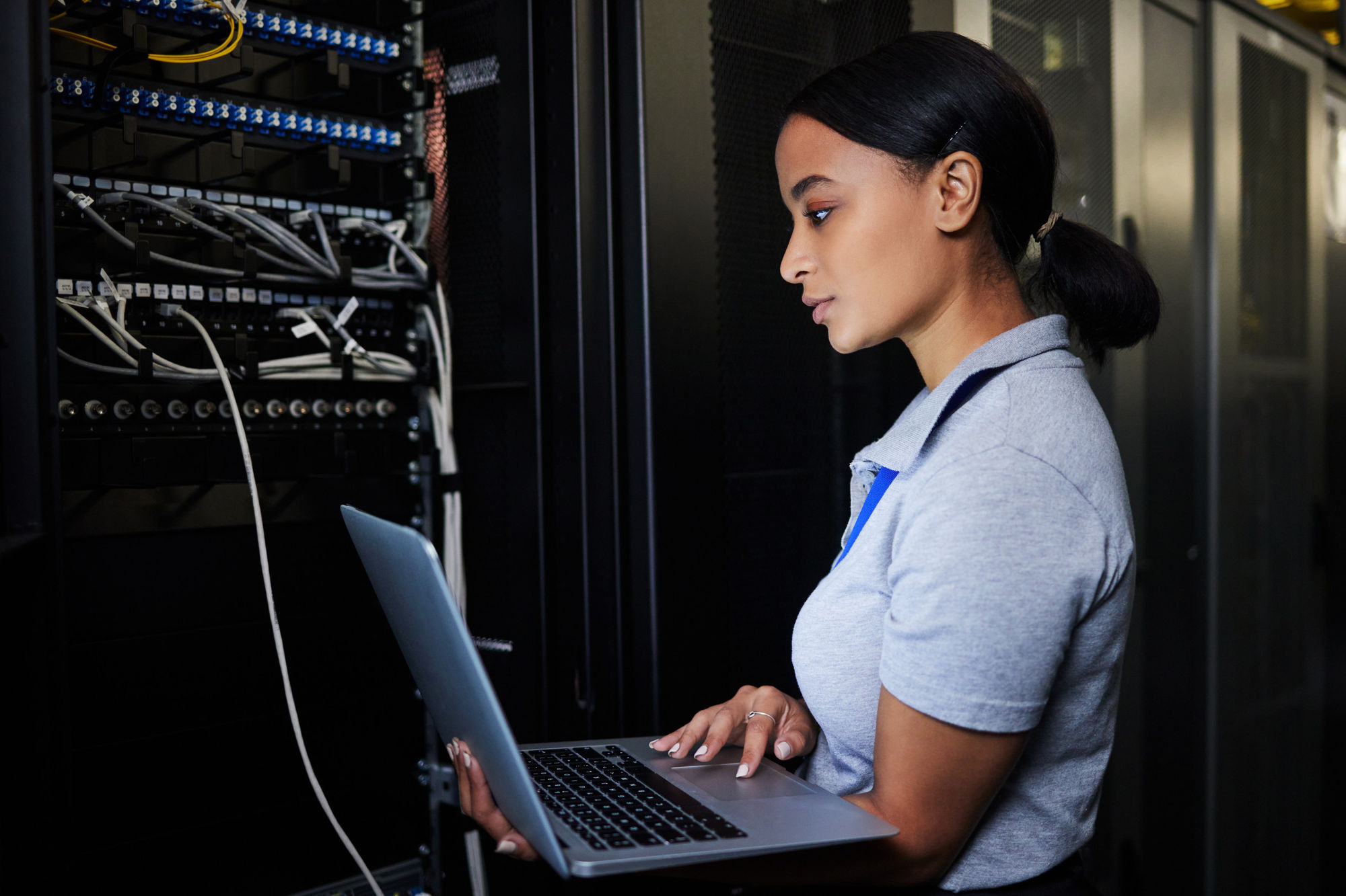 Technician looking at server and computer