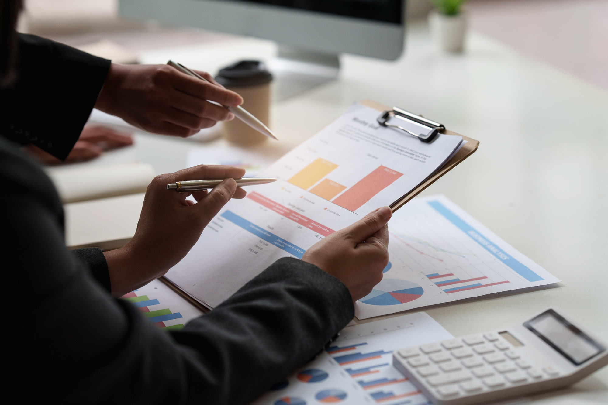 Business people reviewing printed charts