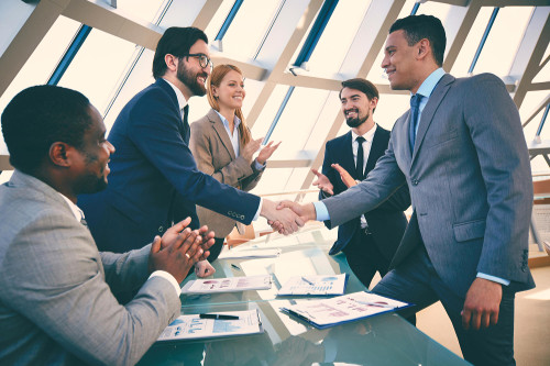 Business partners shaking hands to conclude a meeting