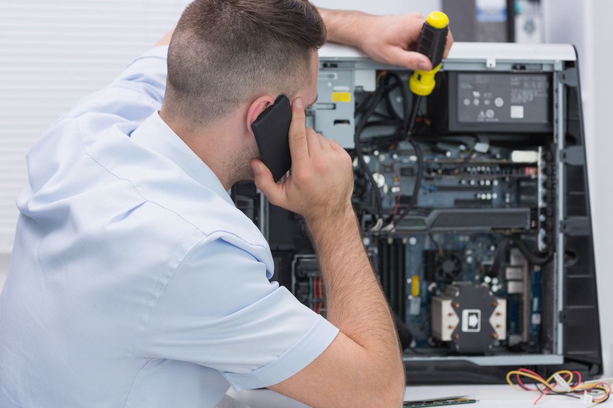 Technician working on the inside of a PC