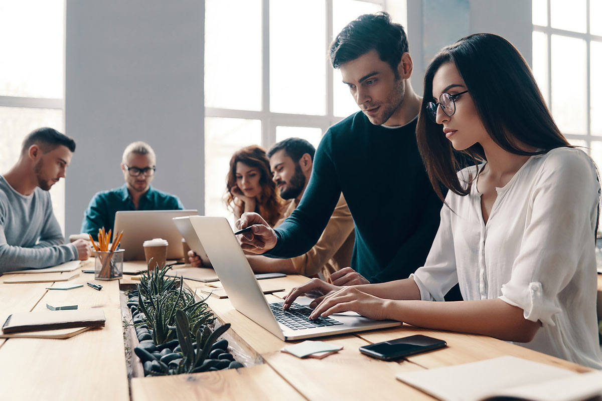 Team of modern young professions working in a creative office